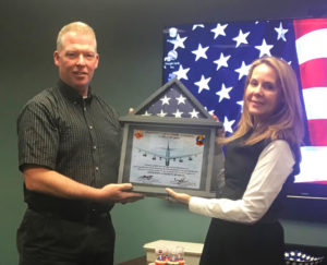 Mike Bouis presenting Rochelle Stachel with flag